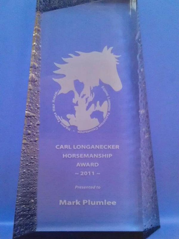 A crystal glass award reading Carl Longanecker Horsemanship Award 2011 with E.L.P.O. Logo engraved