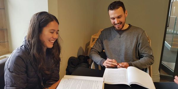 Two people studying together and smiling.
