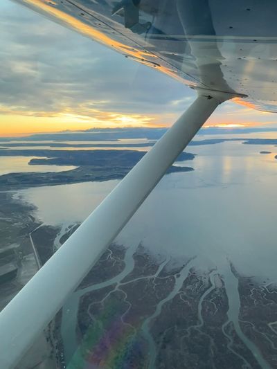 View of a river delta and islands from a small airplane at sunset.