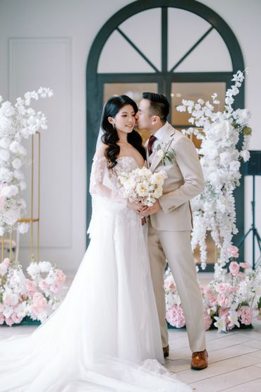 Bride and groom sharing a tender moment during their wedding ceremony.