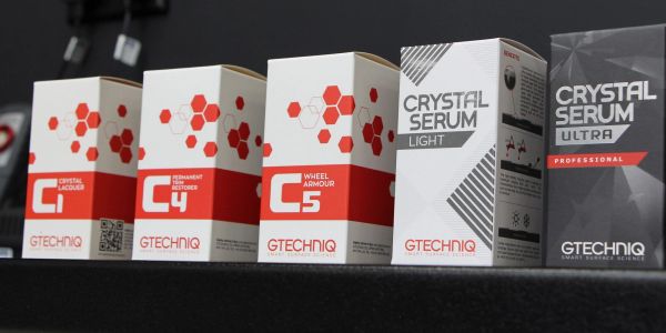 Various Gtechniq car care product boxes lined up on a shelf.