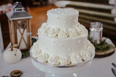 Elegant wedding cake display with lantern décor in Lowcountry reception