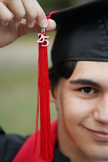 Close-up Charleston graduation portrait featuring red tassel and cap