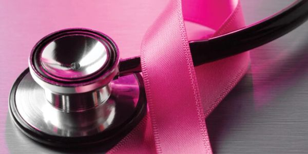 Stethoscope with pink breast cancer awareness ribbon.