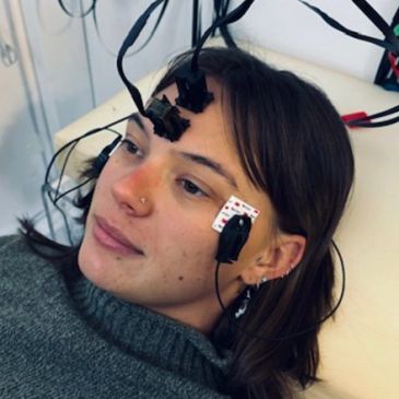 Woman with neurological sensors on her head and face.