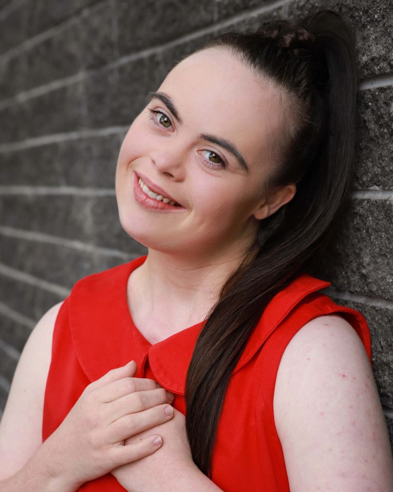 Girl in red dress smiling to camera