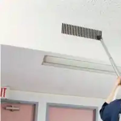 Man vacuuming a vent with a backpack vacuum