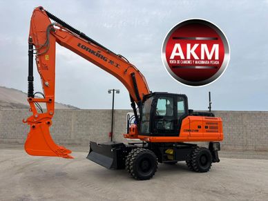 Bright orange excavator with wheels parked on a concrete surface under an overcast sky.