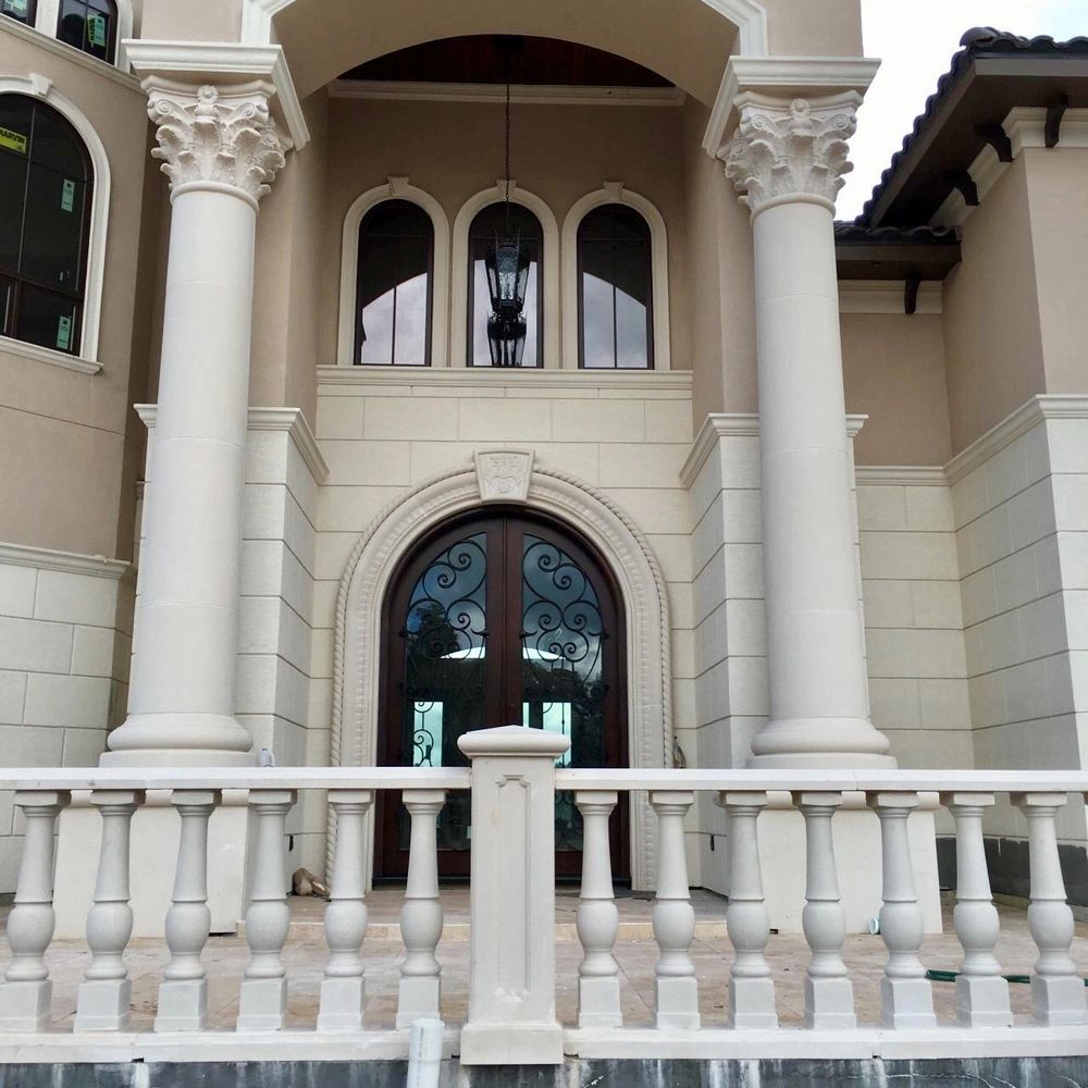 Cast stone entryway with balustrade systems, Corinthian columns, cladding, window & door trim