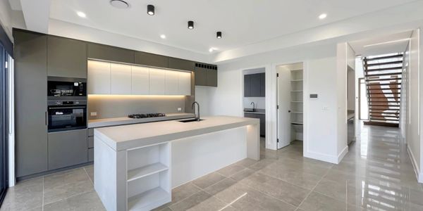 Modern kitchen with a large island and sleek cabinetry.