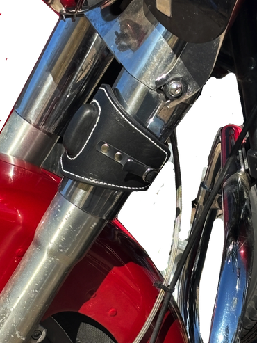 Motorcycle engine featuring chrome accents and a practical black leather cup holder.