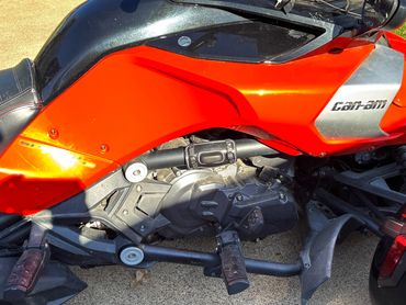 Black leather cup holder attached to a chrome-accented motorcycle engine.