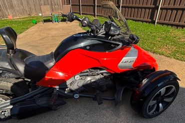 Black leather cup holder mounted on a polished chrome motorcycle engine.