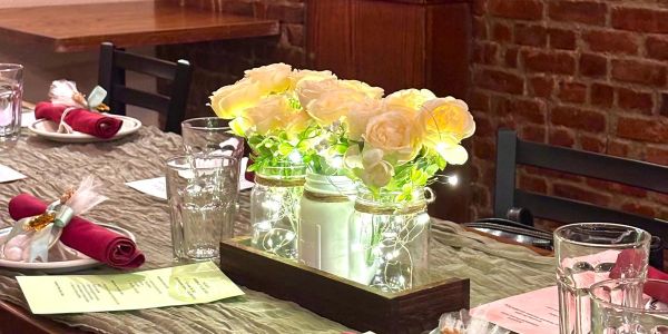 Table centerpiece with flowers and fairy lights.