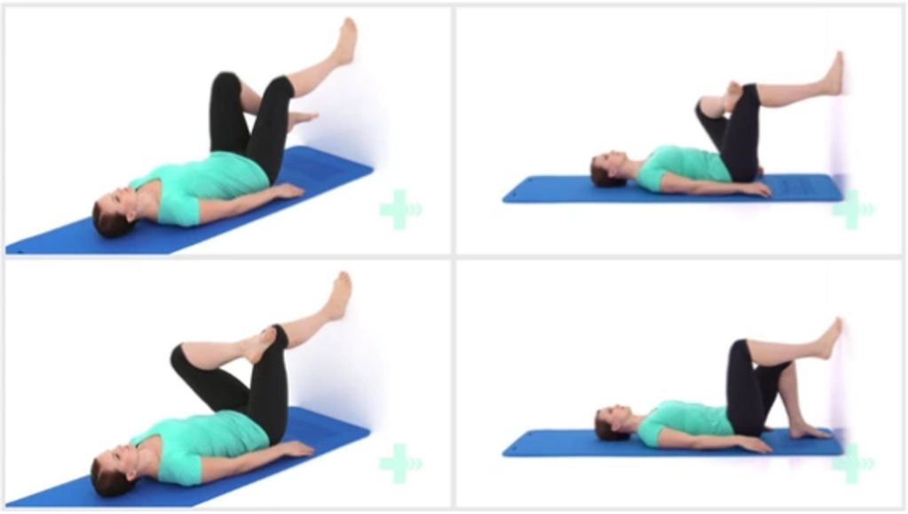 Woman doing piriformis stretch on a blue yoga mat at home
