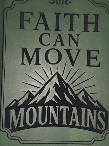 Inspirational sign saying 'Faith Can Move Mountains' with mountain illustration.