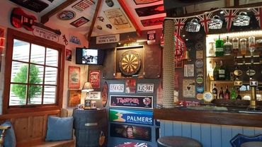 Cozy pub corner with dartboard and vintage decor.