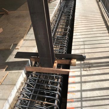 Steel reinforcement bars and columns in a concrete construction site.