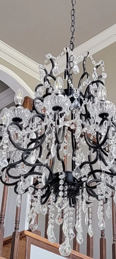 Chandelier installed on high ceiling. 