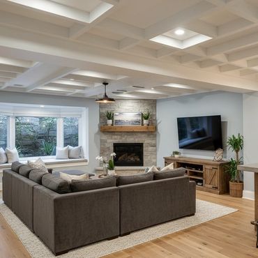 Cozy living room with a large sectional sofa, fireplace, and modern bar area with wooden accents.