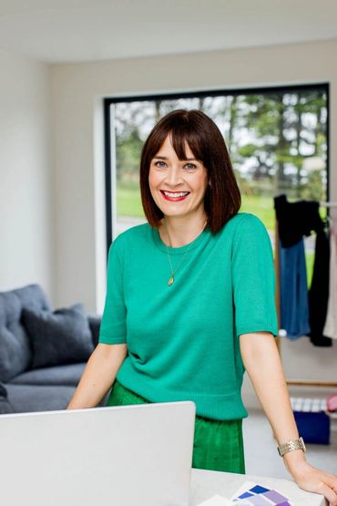 Woman standing at desk.