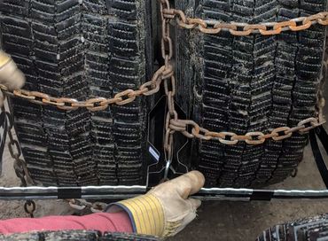 ChainCheater grabs the center rail in its jaws, squeezed in place with pressure from the dual tires.