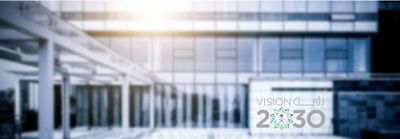 Blurred modern building with Vision 2030 logo in the foreground.