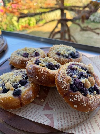 Blueberry pastries with crumb topping on a tray.