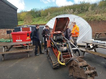 One of the Knighton Countryside Management Team talking to Dorset Student School students. next to a