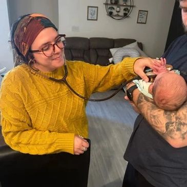 Midwife checking on baby