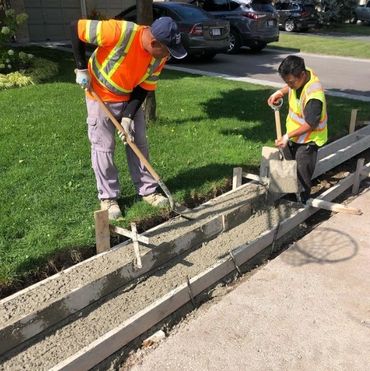 Workers making a curb and sidewalk