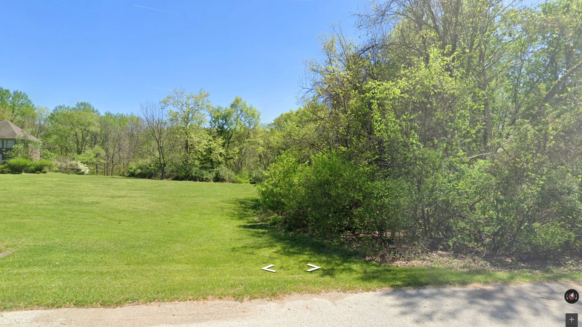 Street view of a 16-acre wooded land parcel in desirable Tailwater Run subdivision near Lake Monroe,