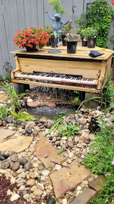 Baby Grand Piano turned into waterfall feature and pond.