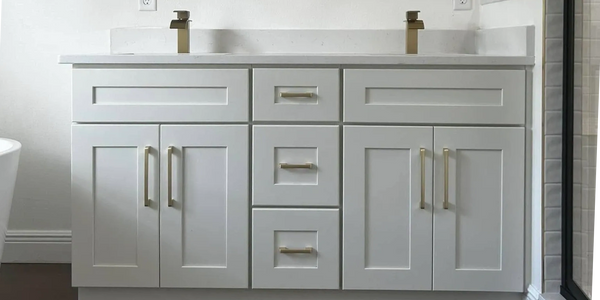 Modern bathroom vanity with white shaker cabinets with gold fixtures