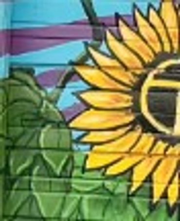 Clue #3: Colorful mural featuring a large sunflower against a purple and blue background.