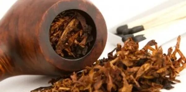 Tobacco pipe with loose tobacco and matches.