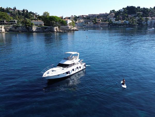 Our Boat at anchor in Villefranche Bay with Paddleboarding and other water toys