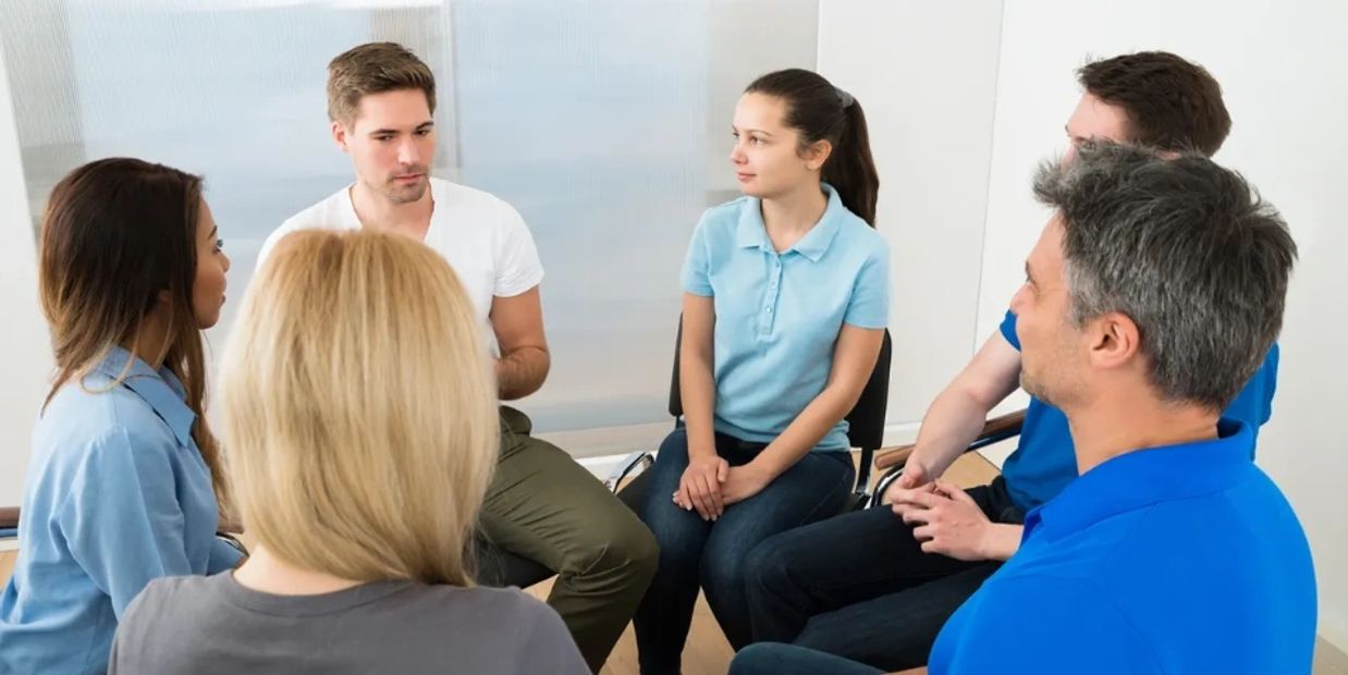 Group of people sitting in a circle for counseling