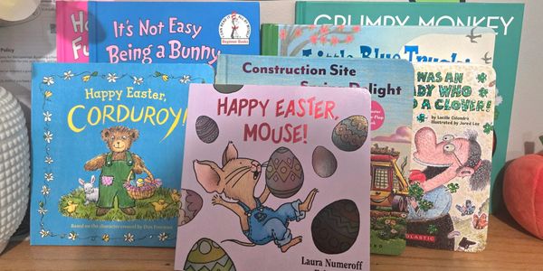 A collection of colorful children's Easter-themed books displayed on a shelf.