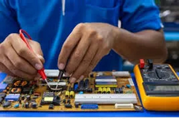 Person using a multimeter to test a circuit board.