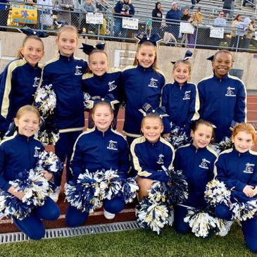 Spring-Ford Youth Football & Cheer cheerleaders posing before a football game.