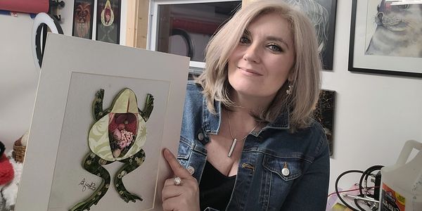 Quilling Artist Stacy Bettencourt displaying one of her favorite pieces, "Frog Autopsy," 2023