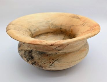 Handcrafted wooden bowl with natural grain patterns and smooth finish.