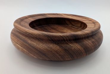 Smoothly crafted wooden bowl with rich grain patterns.