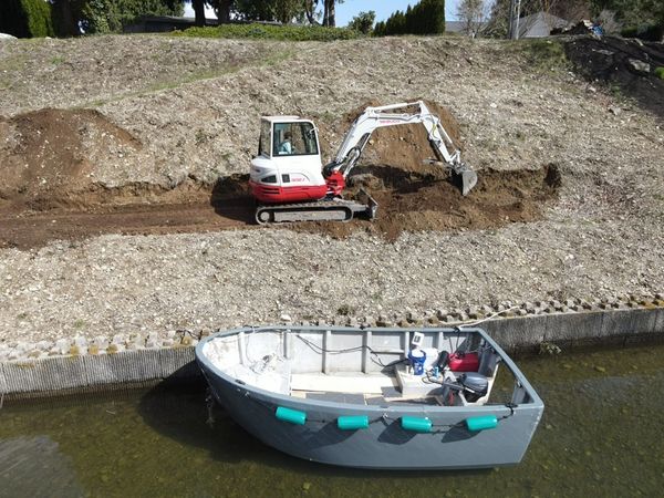 Lake Tapps boat and excavator grading the slope