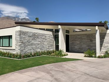 Palm Springs Ca desert modern entry with a sloped roof and stone by R.L. Osborn Architect.