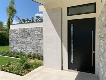 Palm Springs desert modern entry door with pivot hinges and transom window by R.L. Osborn Architect.