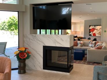 Palm Springs desert modern residence drop down TV and peninsula fireplace by R.L. Osborn Architect.