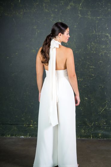 Bridal jumpsuit with open back and silk tie draped detail.