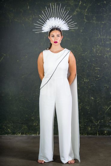 tailored wedding jumpsuit with one shoulder cape and black edge detailing.